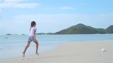 Sahilde hareketli küçük bir kız çok eğleniyor..