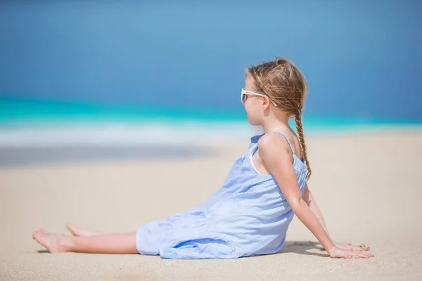 Beautiful little girl in dress at beach having fun. — Stock Photo, Image
