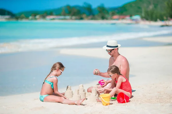 Rodinná výroba písku hrad na tropické bílé pláži — Stock fotografie