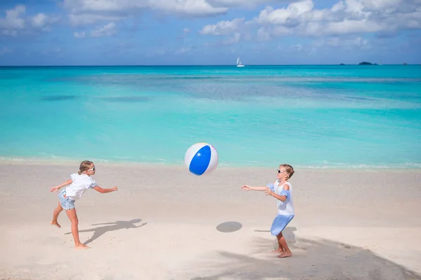 Little adorable girls playing with ball on the beach — Stock Photo, Image