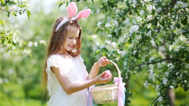 Adorable little girl in blooming apple garden on beautiful spring day — Stock Video