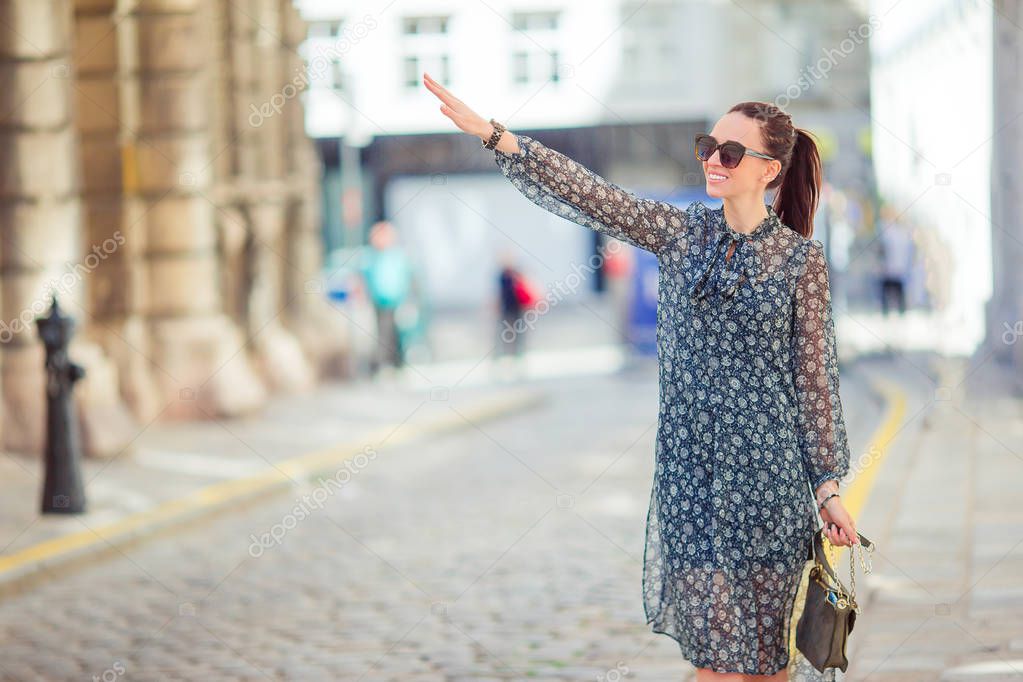 Woman walking in city. Young attractive tourist outdoors in european city