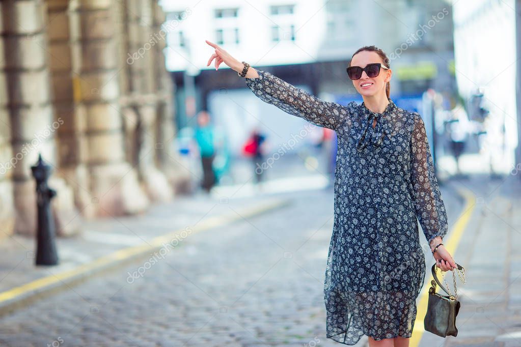 Woman walking in city. Young attractive tourist outdoors in european city