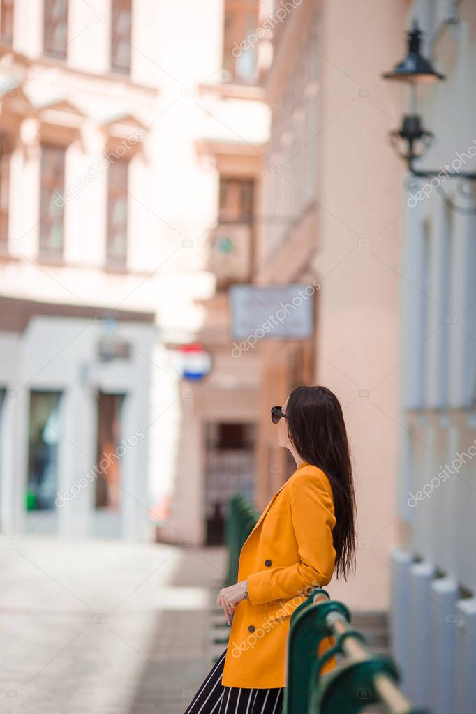 Woman walking in city. Young attractive tourist outdoors in european city