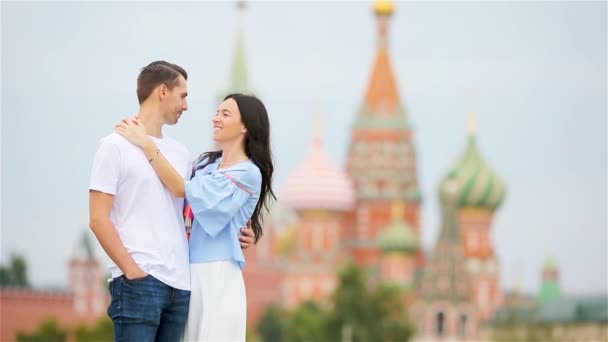 Young dating couple in love walking in city background St Basils Church — Stock Video