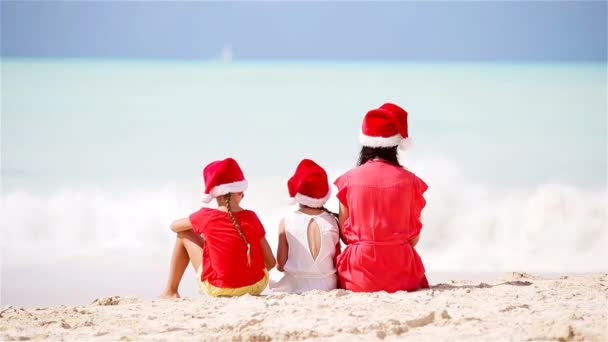 Счастливая мама и маленькие девочки в шляпе Санта на летних каникулах — стоковое видео
