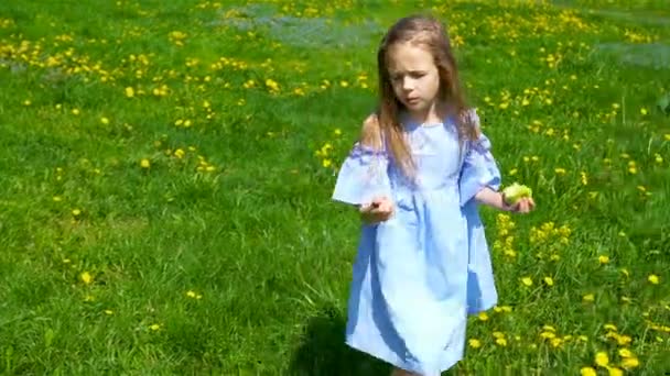 Adorable little girl in blooming apple garden on beautiful spring day — Stock Video