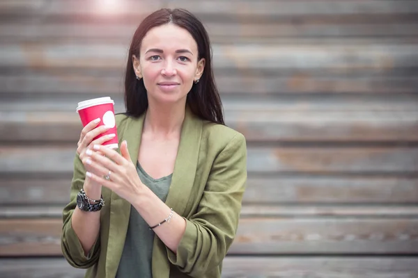 Woman drinking tasty coffee outdoors in the park