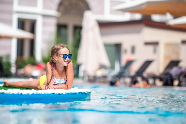 Hermosa niña divirtiéndose cerca de una piscina al aire libre —  Fotos de Stock