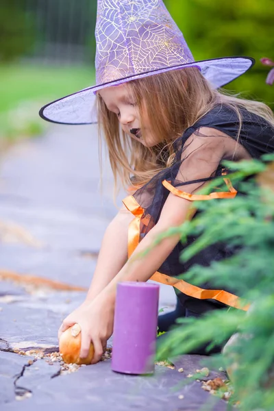 Adorable little girl wearing witch costume on Halloween at autumn day. Trick or treat. — Stock Photo, Image