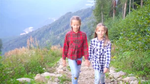 Красиві щасливі маленькі дівчата в горах на тлі туману — стокове відео