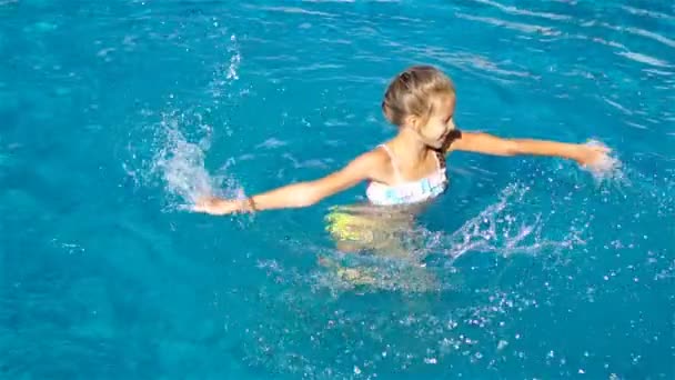 Adorable little girl in outdoor swimming pool — Stock Video