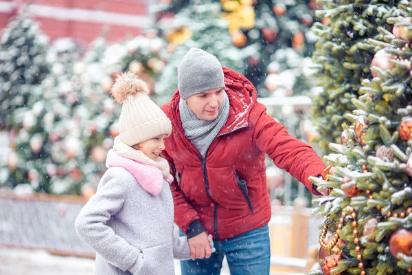 Liten lykkelig jente nær gran i snø til nyttår . – stockfoto