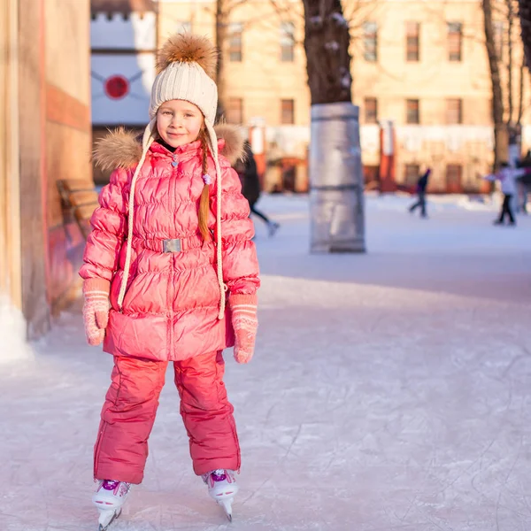 Adorable niña disfrutando patinando en la pista de hielo — Foto de Stock