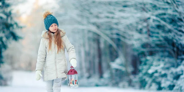 Urocza dziewczynka z latarką i świeca w zimie — Zdjęcie stockowe