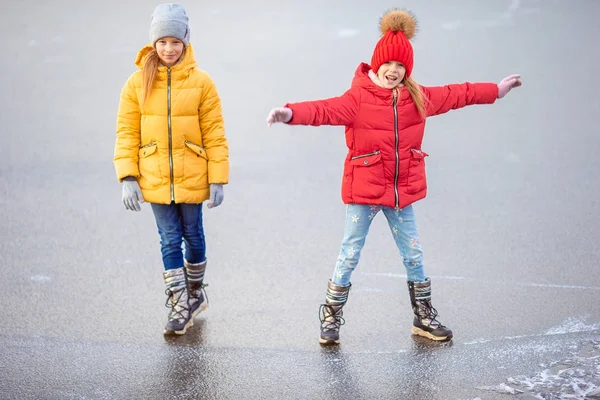 Adorable little girls skating on the ice-rink — Stock Photo, Image