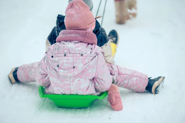 Adorable little happy girls sledding in winter snowy day. — Stock Photo, Image