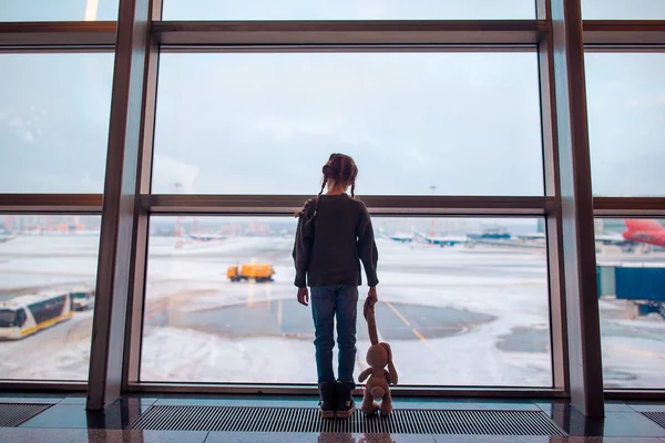 Little girl in airport near big window while wait for boarding — Stock Photo, Image