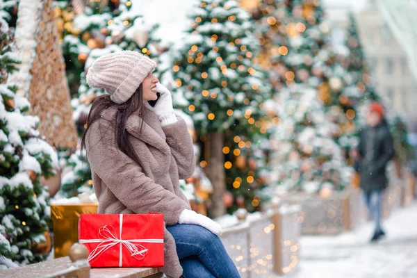 Happy girl near fir-tree branch in snow for new year. — Stock Photo, Image