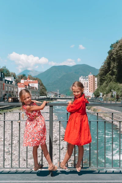 Kızlar arkadan görünüm üzerinde bir Avrupa şehirde bir dağ nehir çıkabilir.
