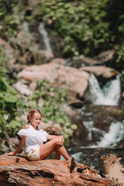 Little girl enjoying view of waterfall in Krasnay Poliana — Stock Photo, Image