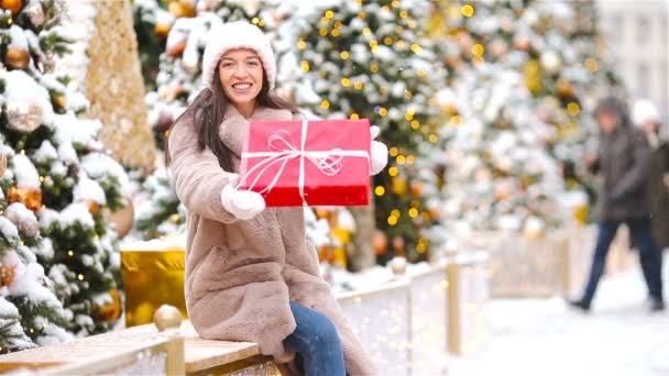 Happy girl near fir-tree branch in snow for new year. — Stock Video