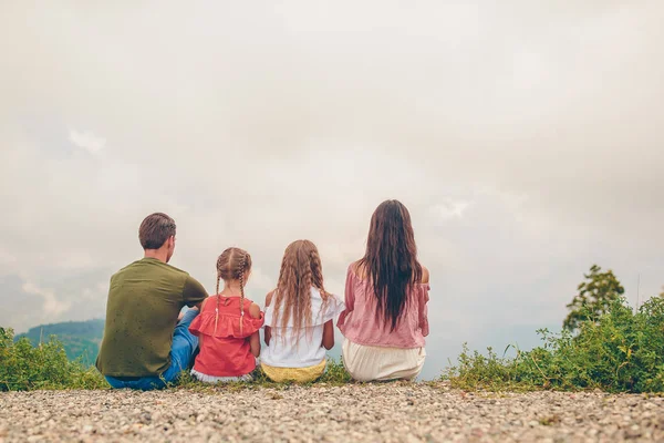 Beautiful happy family in mountains in the background of fog — Stock Photo, Image