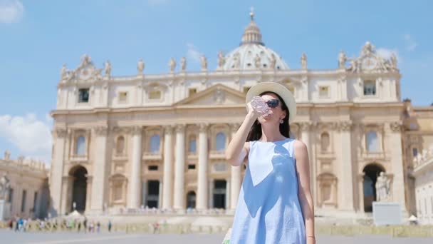 Young woman drinking water background at St. Peters Basilica church in Vatican city, Rome, Italy. — Stock Video