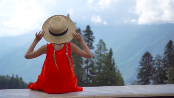 Hermosa niña feliz en las montañas en el fondo de la niebla — Vídeos de Stock