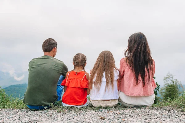 Beautiful happy family in mountains in the background of fog — Stock Photo, Image