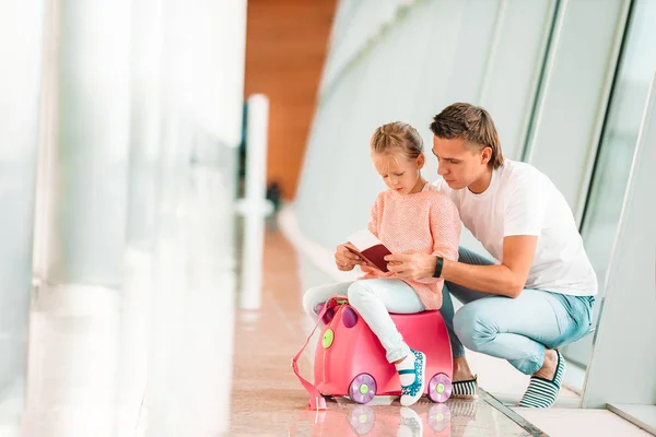 Glücklicher dada und kleines mädchen mit bordkarte am flughafen — Stockfoto