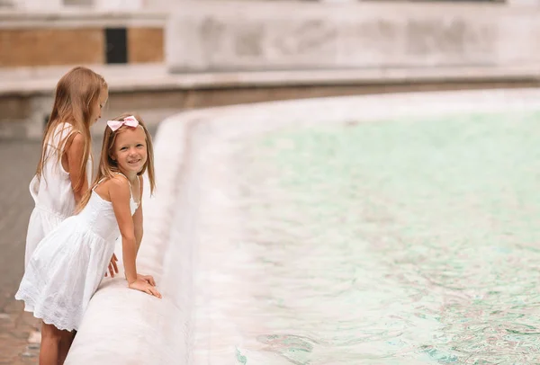 Little beautiful girls near fountain Fontana di Trevi — Stock Photo, Image