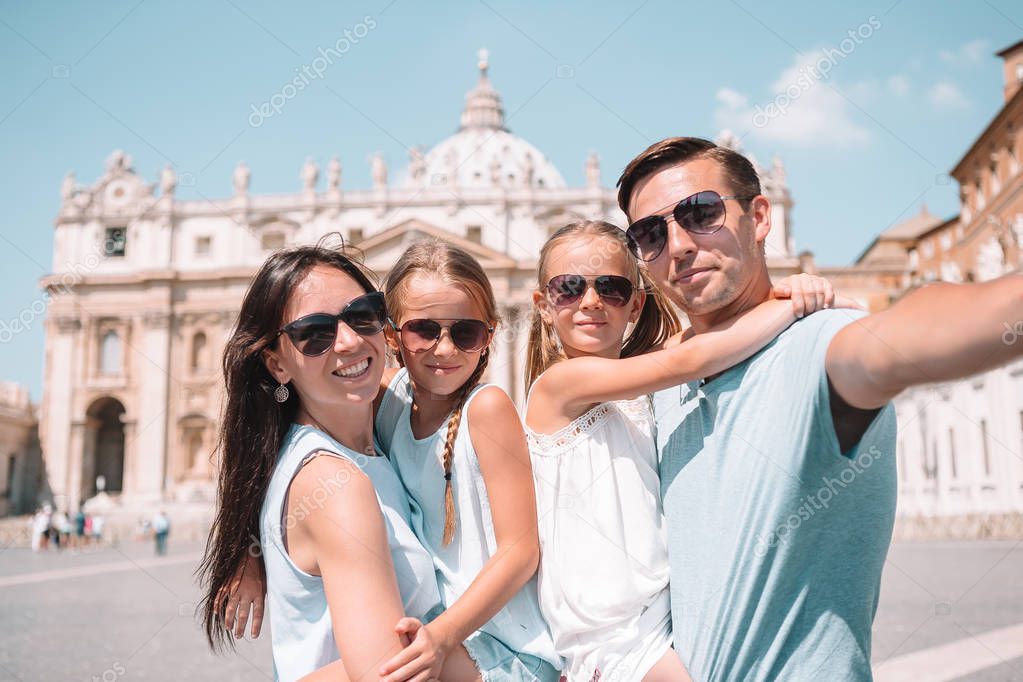 Happy family taking selfie in Vatican city and St. Peters Basilica church, Rome, Italy