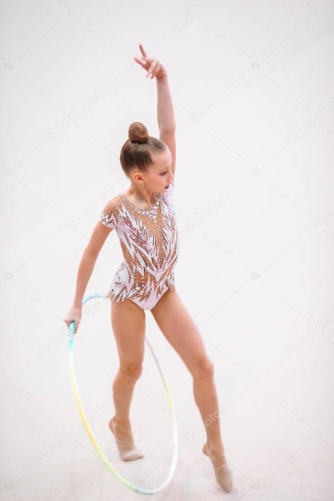 Little gymnast training on the carpet and ready for competitions