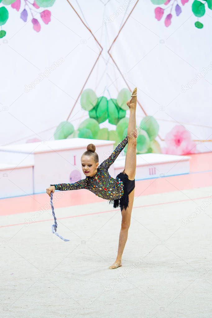 Little gymnast training on the carpet and ready for competitions