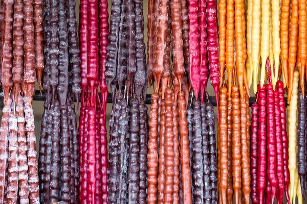 Multicolored delicious fresh Georgian Sweets Churchkhela hanging in the market — Stock Photo, Image