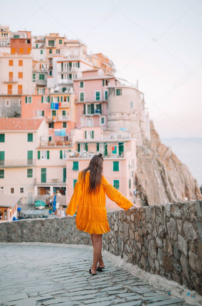 Tourist looking at scenic view of Manarola, Cinque Terre, Liguria, Italy