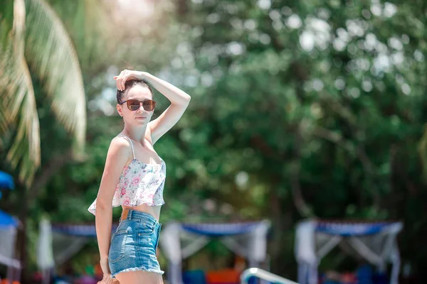 Hermosa chica joven relajándose cerca de la piscina — Foto de Stock