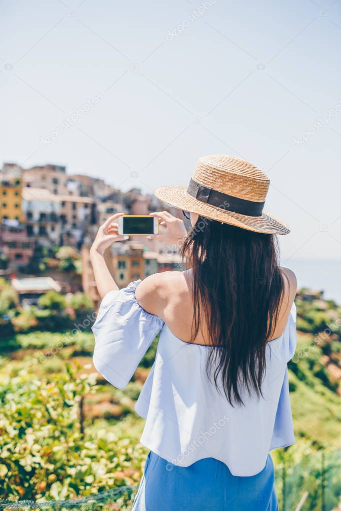 Tourist looking at scenic view of Vernazza, Cinque Terre, Liguria, Italy