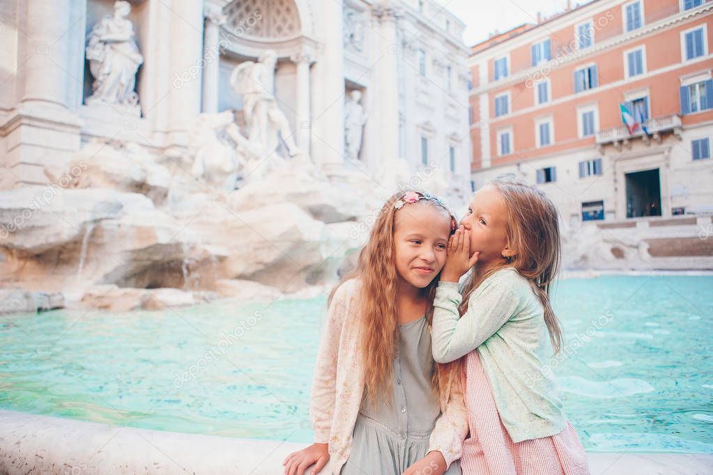 Adorable little girls near the Fountain of Trevi in Rome.