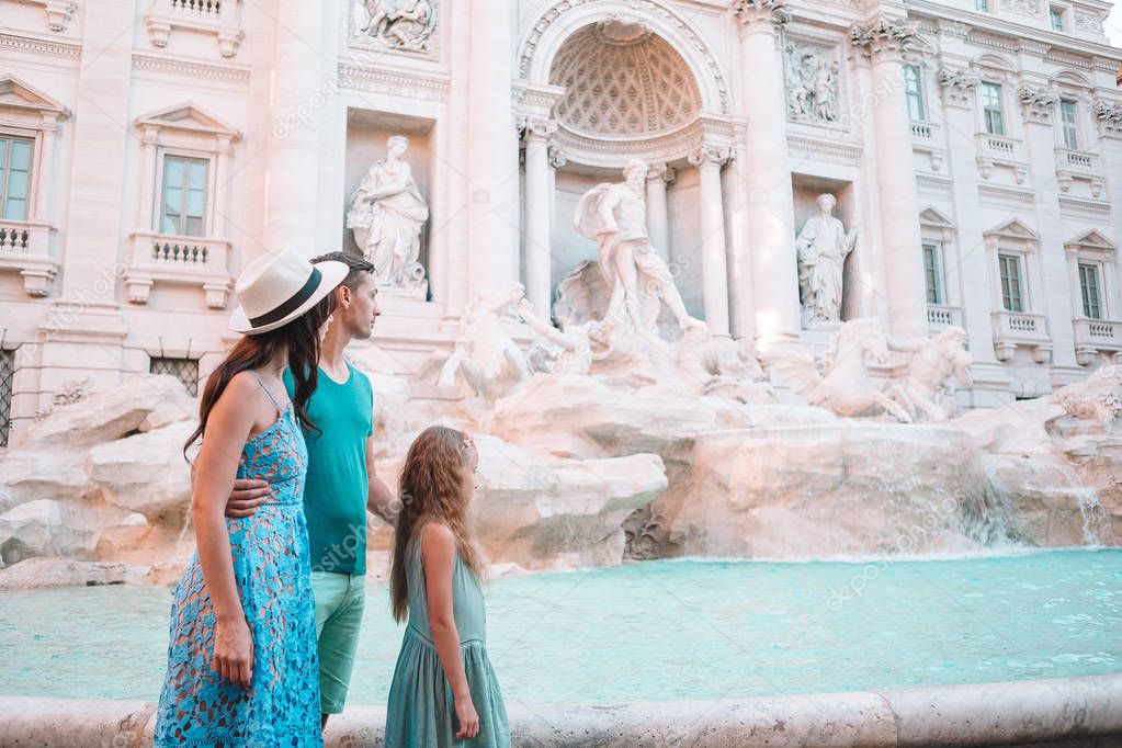 Happy family near Fontana di Trevi with city map