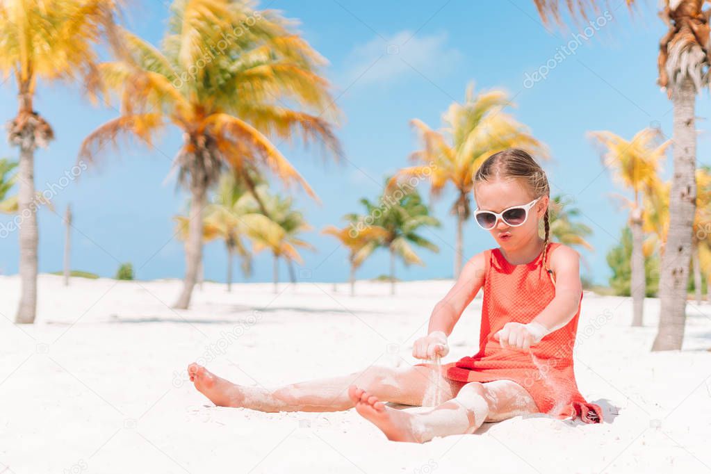 Cute little girl at beach enjoying caribbean vacaion