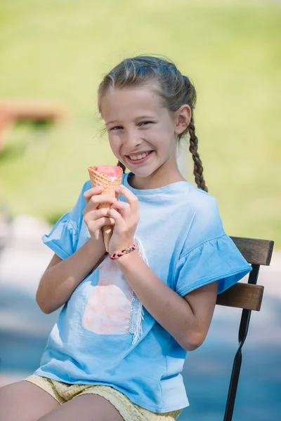 在夏天在室外咖啡馆在户外吃冰淇淋的小女孩 — 图库照片