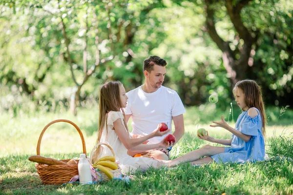 Happy father and little daughers relax by the lake — Stock Photo, Image