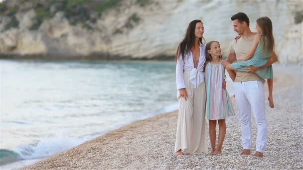 Happy beautiful family with kids on the beach — Stock Video