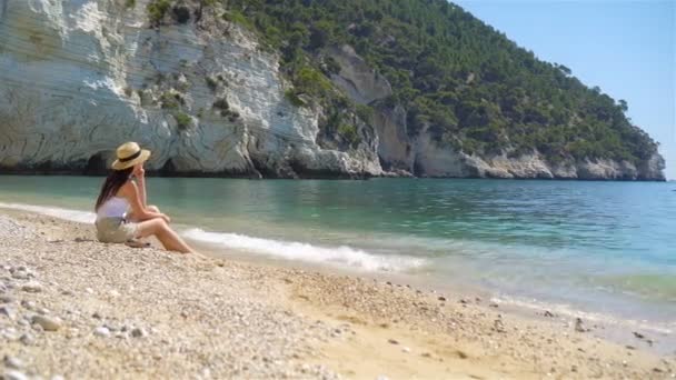 Young beautiful woman on white tropical beach. — Stock Video