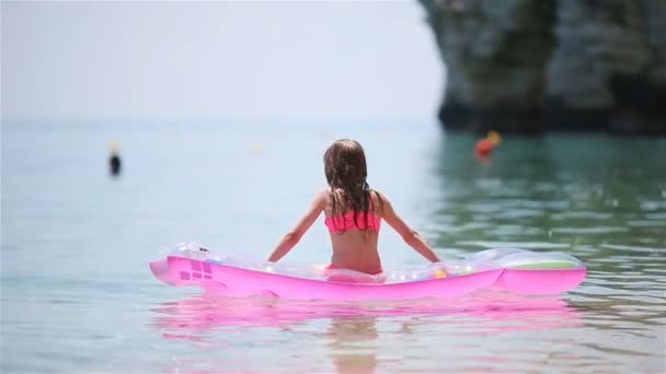 Adorable girl with inflatable mattress in outdoor swimming pool — Stock Video