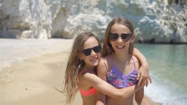 Μικρά κορίτσια που διασκεδάζουν στην τροπική παραλία κατά τη διάρκεια των καλοκαιρινών διακοπών — Αρχείο Βίντεο