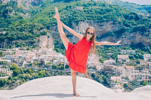 Adorable little girl on warm and sunny summer day in Positano town in Italy — Stock Photo, Image