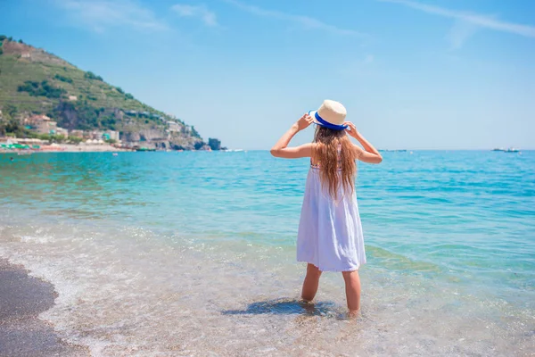 Όμορφο κοριτσάκι στην παραλία που διασκεδάζει. Αστείο κορίτσι απολαύστε τις καλοκαιρινές διακοπές. — Φωτογραφία Αρχείου